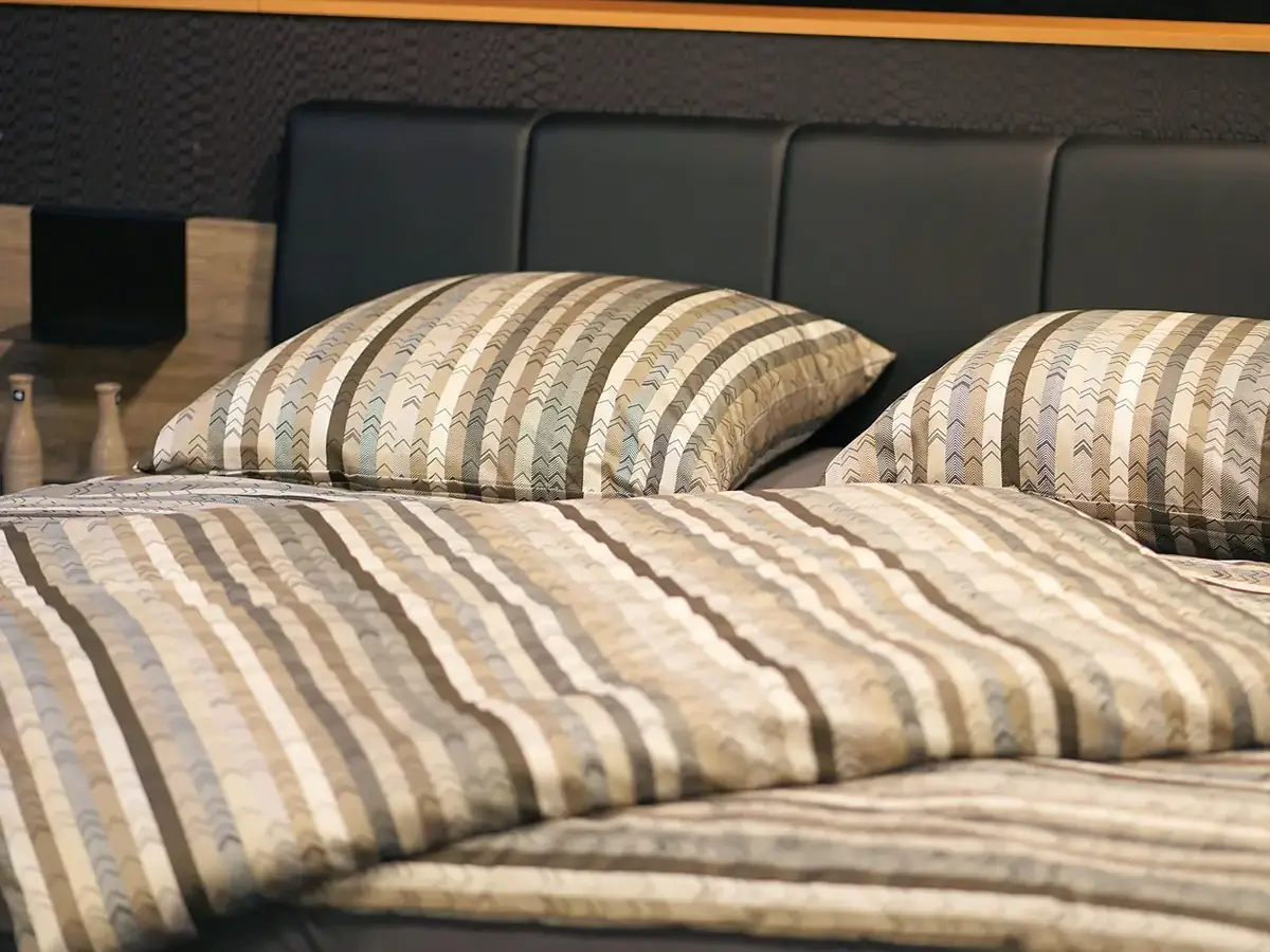Folded white bedsheets and linen for hospitals and hotels